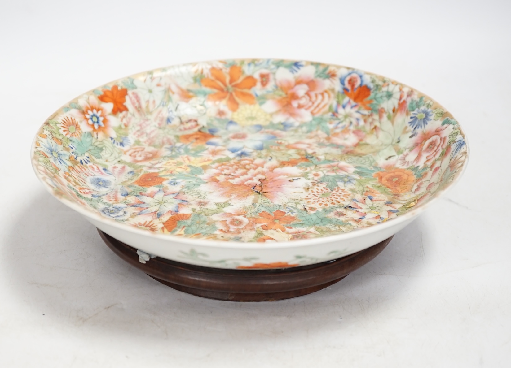 A Chinese enamelled porcelain millefleur dish, Qianlong mark, early 20th century, 24cm diameter. Condition - good